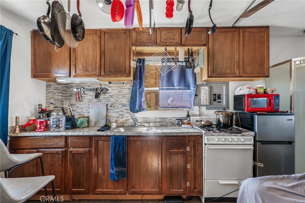800 Brant Cross Road Twentynine Palms, CA 92277 - Photo 7 of 52 a kitchen with stainless steel appliances granite countertop a sink stove and cabinets