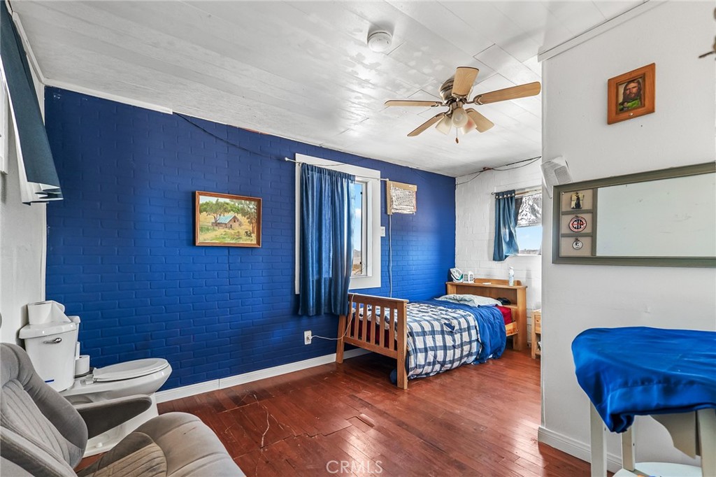 800 Brant Cross Road Twentynine Palms, CA 92277 - Photo 10 of 52 a bedroom with a bed and wooden floor