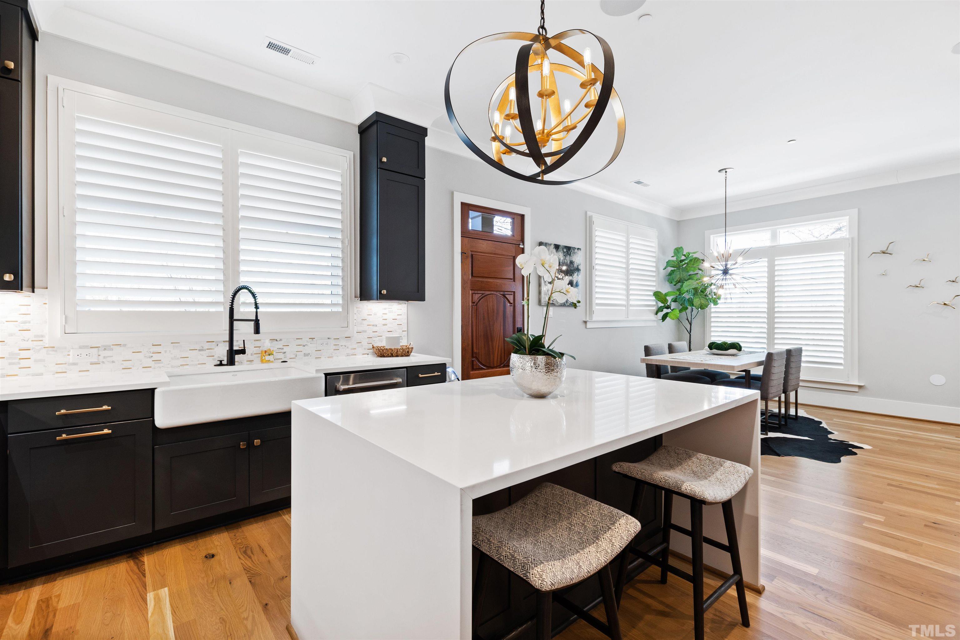 910 Oberlin Road, Unit 103 Raleigh, NC 27605 - Photo 11 of 47 a kitchen with a table and chairs in it