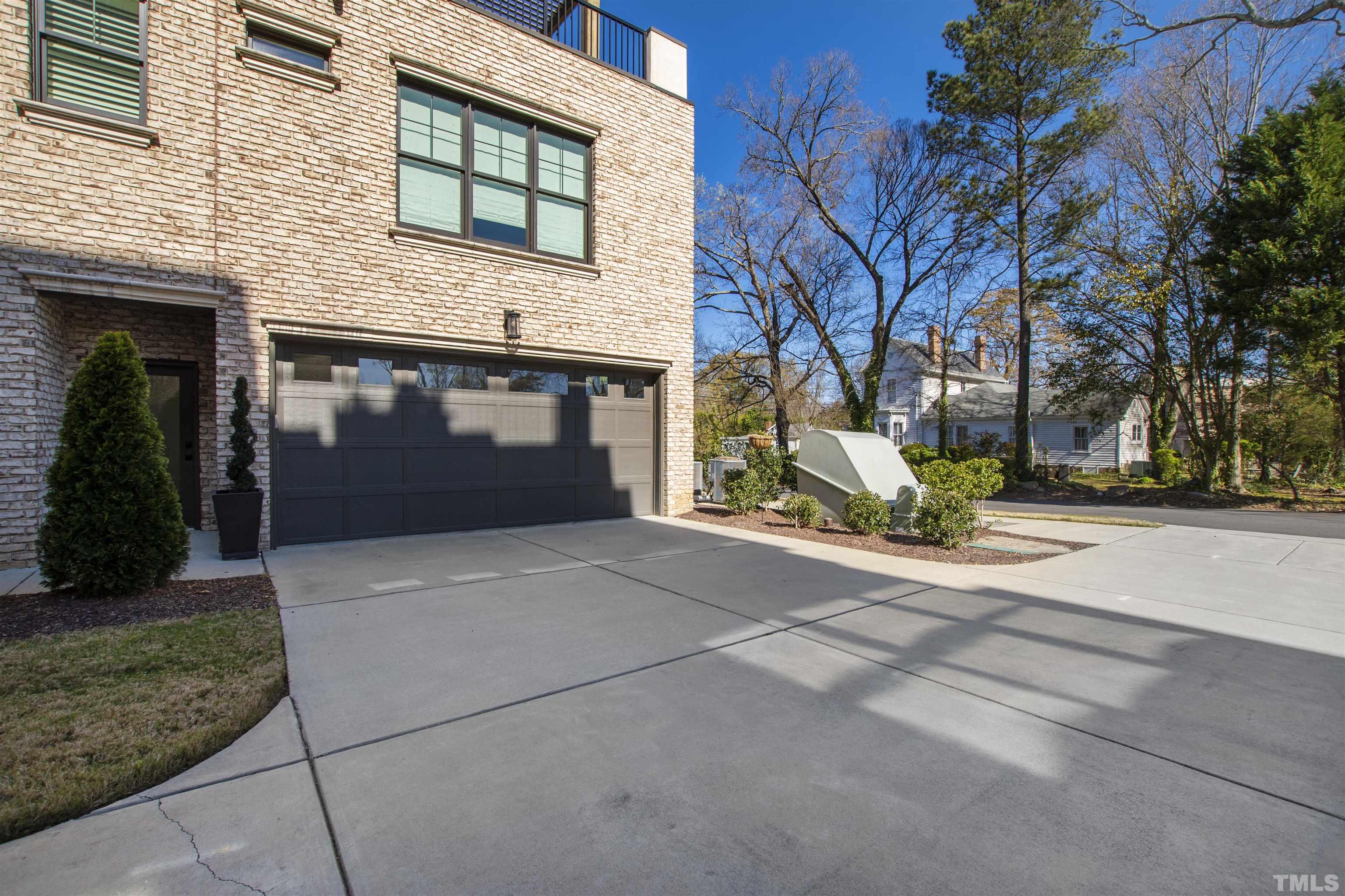 910 Oberlin Road, Unit 103 Raleigh, NC 27605 - Photo 41 of 47 a front view of a house with a yard and garage