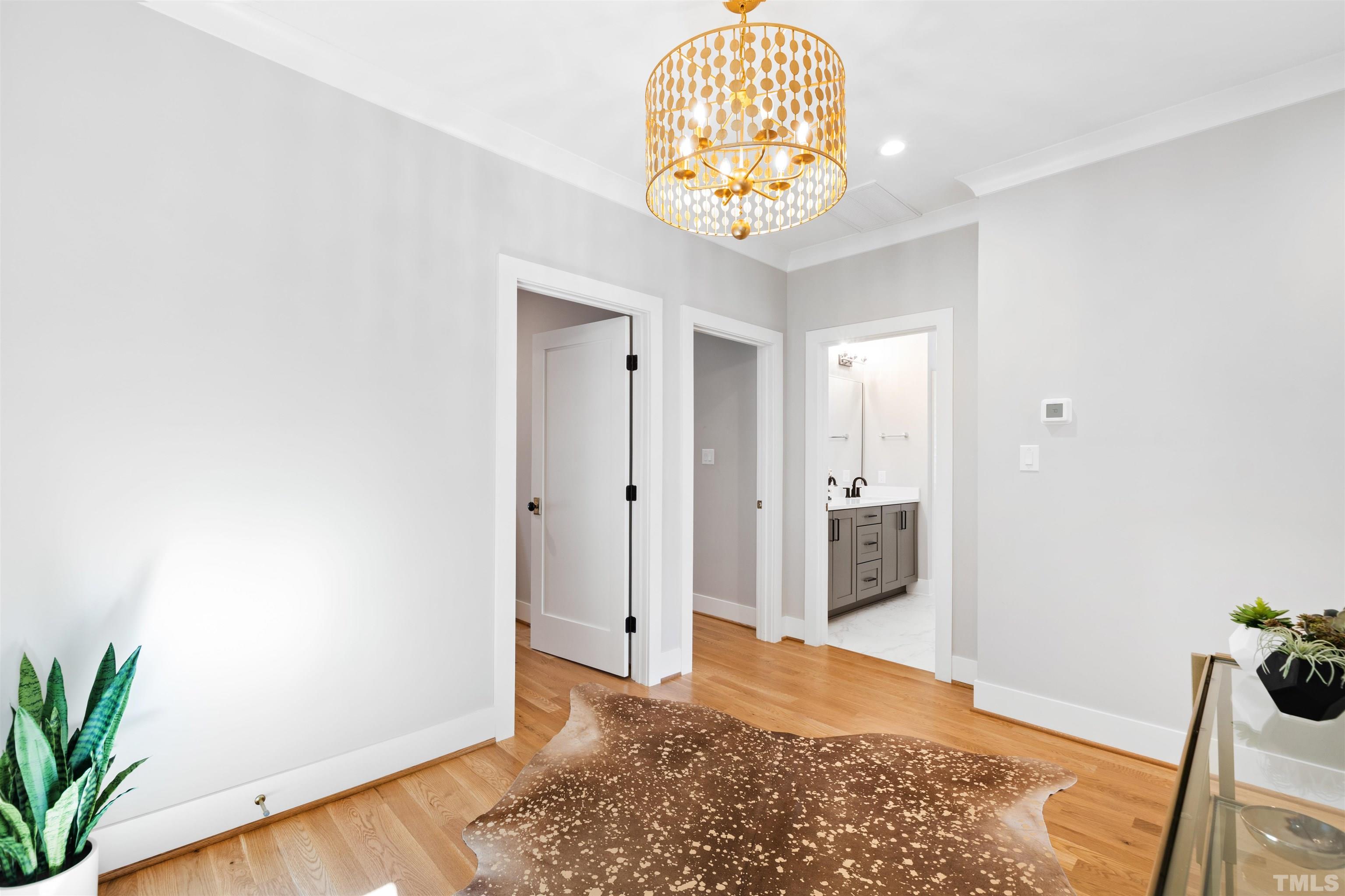910 Oberlin Road, Unit 103 Raleigh, NC 27605 - Photo 44 of 47 a view of a hallway with a chandelier