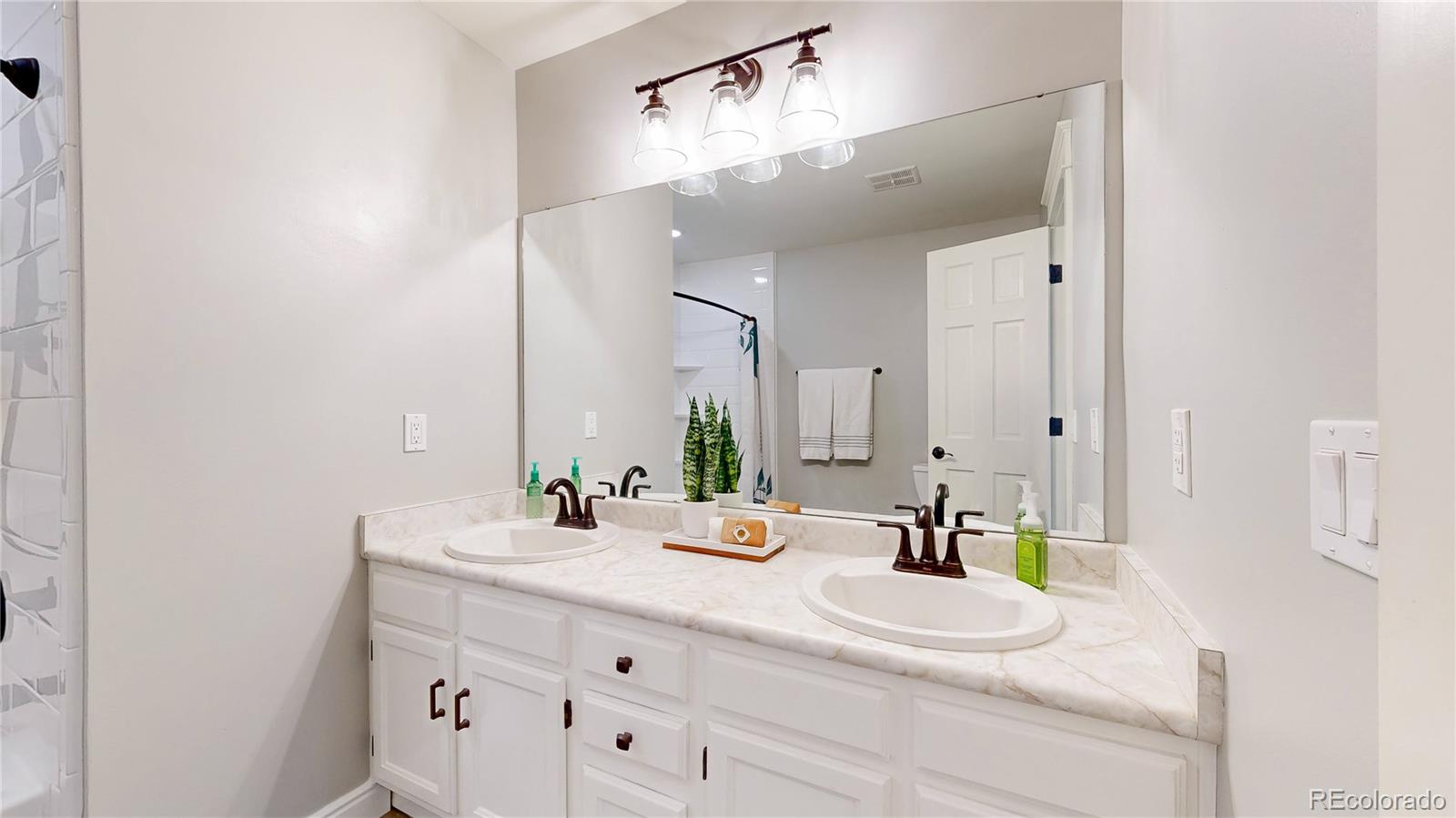 2335 Ranch Drive Westminster, CO 80234 - Photo 17 of 47 a bathroom with a sink and a mirror