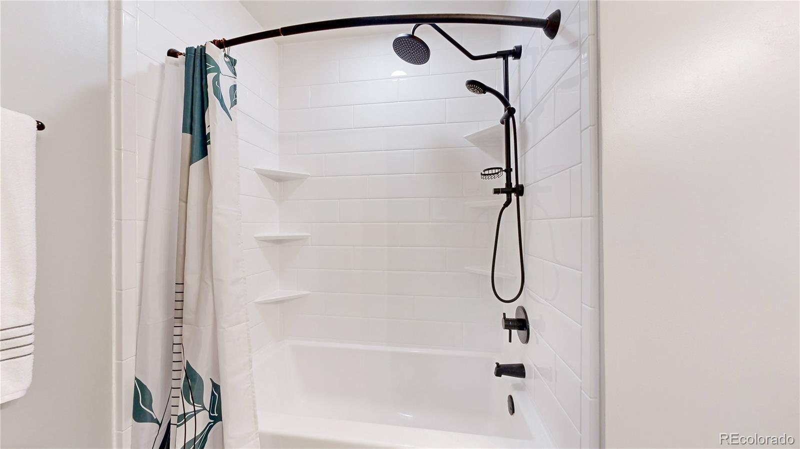 2335 Ranch Drive Westminster, CO 80234 - Photo 18 of 47 a bathroom with a glass shower door