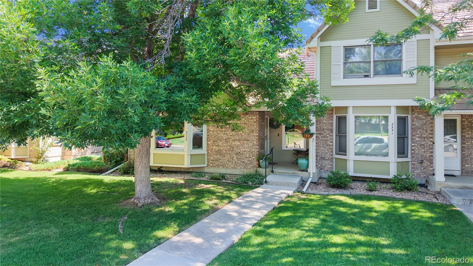 2335 Ranch Drive Westminster, CO 80234 - Photo 2 of 47 a front view of a house with garden