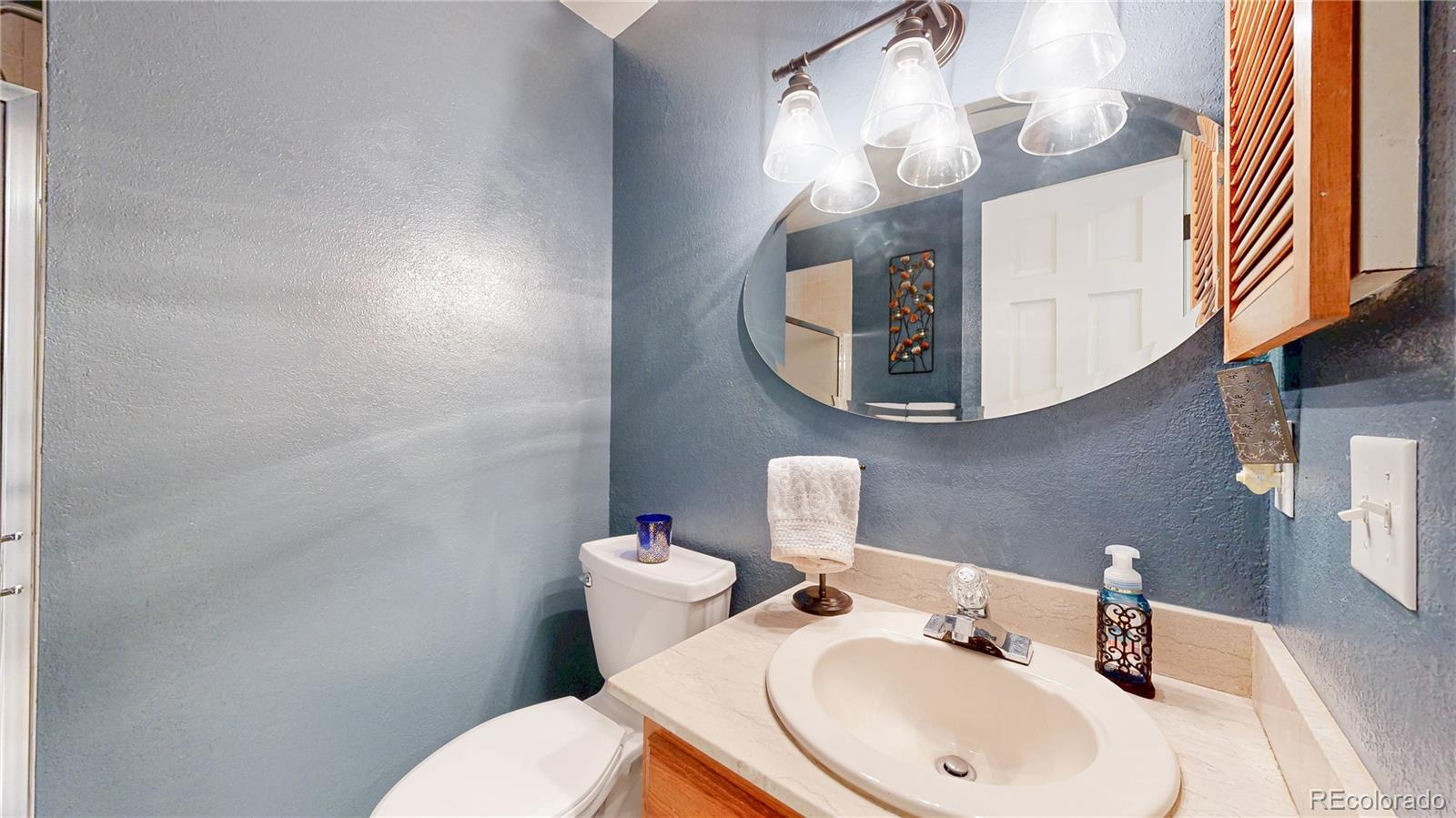 2335 Ranch Drive Westminster, CO 80234 - Photo 21 of 47 a bathroom with a sink mirror and toilet