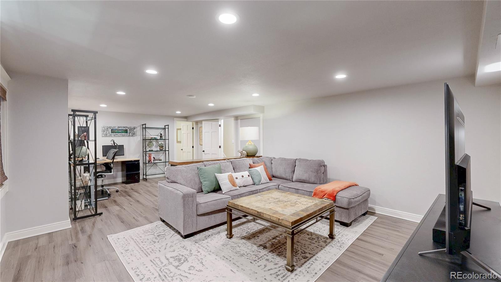 2335 Ranch Drive Westminster, CO 80234 - Photo 23 of 47 a living room with furniture a flat screen tv and a rug