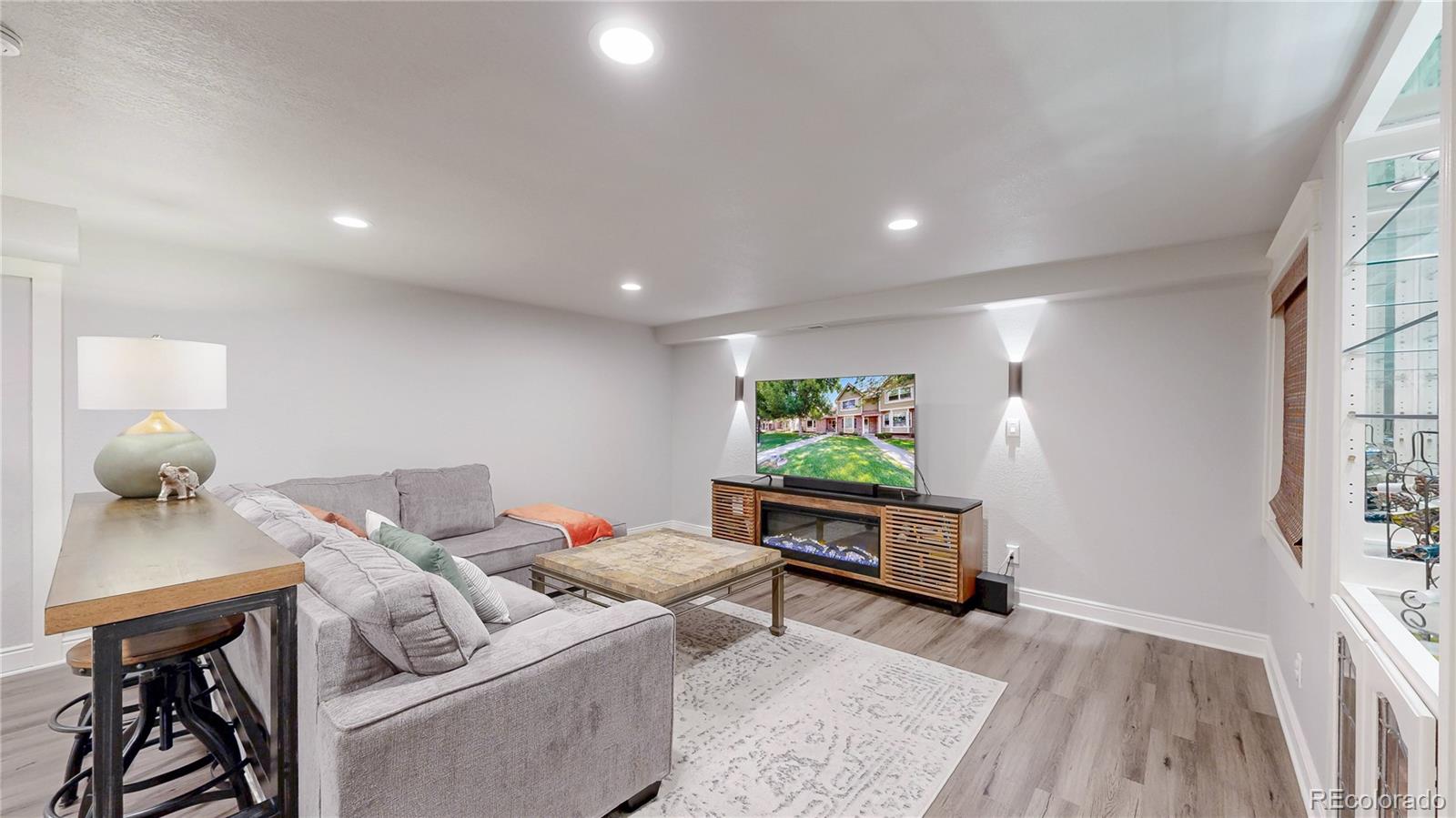 2335 Ranch Drive Westminster, CO 80234 - Photo 25 of 47 a living room with furniture and a wooden floor