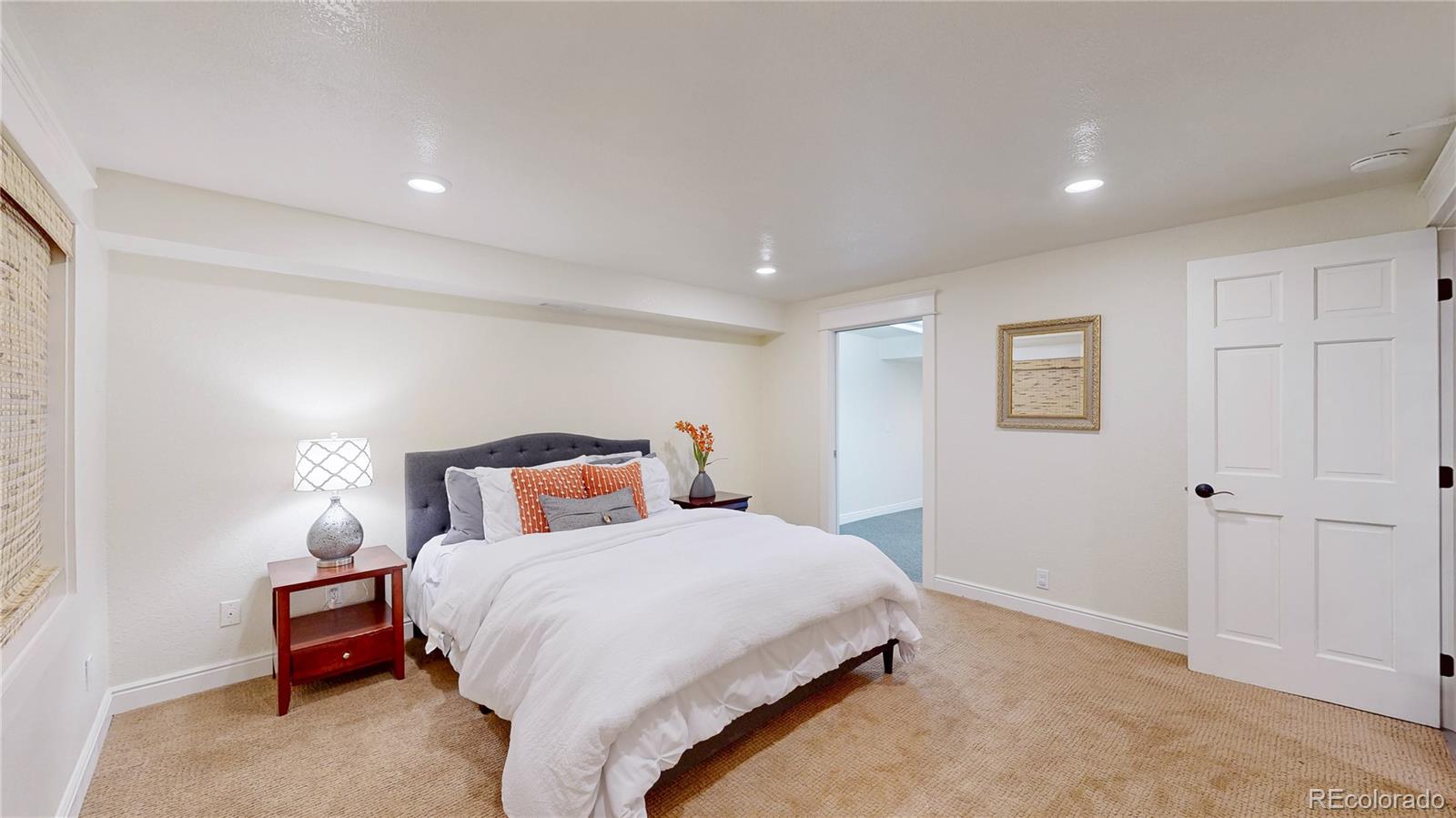 2335 Ranch Drive Westminster, CO 80234 - Photo 27 of 47 a bedroom with a bed and a painting on the wall