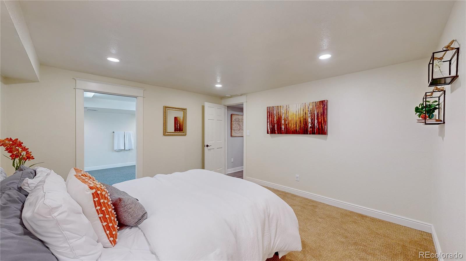 2335 Ranch Drive Westminster, CO 80234 - Photo 28 of 47 a bedroom with a large bed and a couch