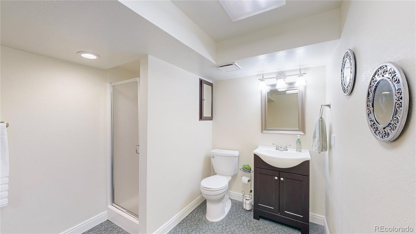 2335 Ranch Drive Westminster, CO 80234 - Photo 29 of 47 a spacious bathroom with a toilet sink and mirror