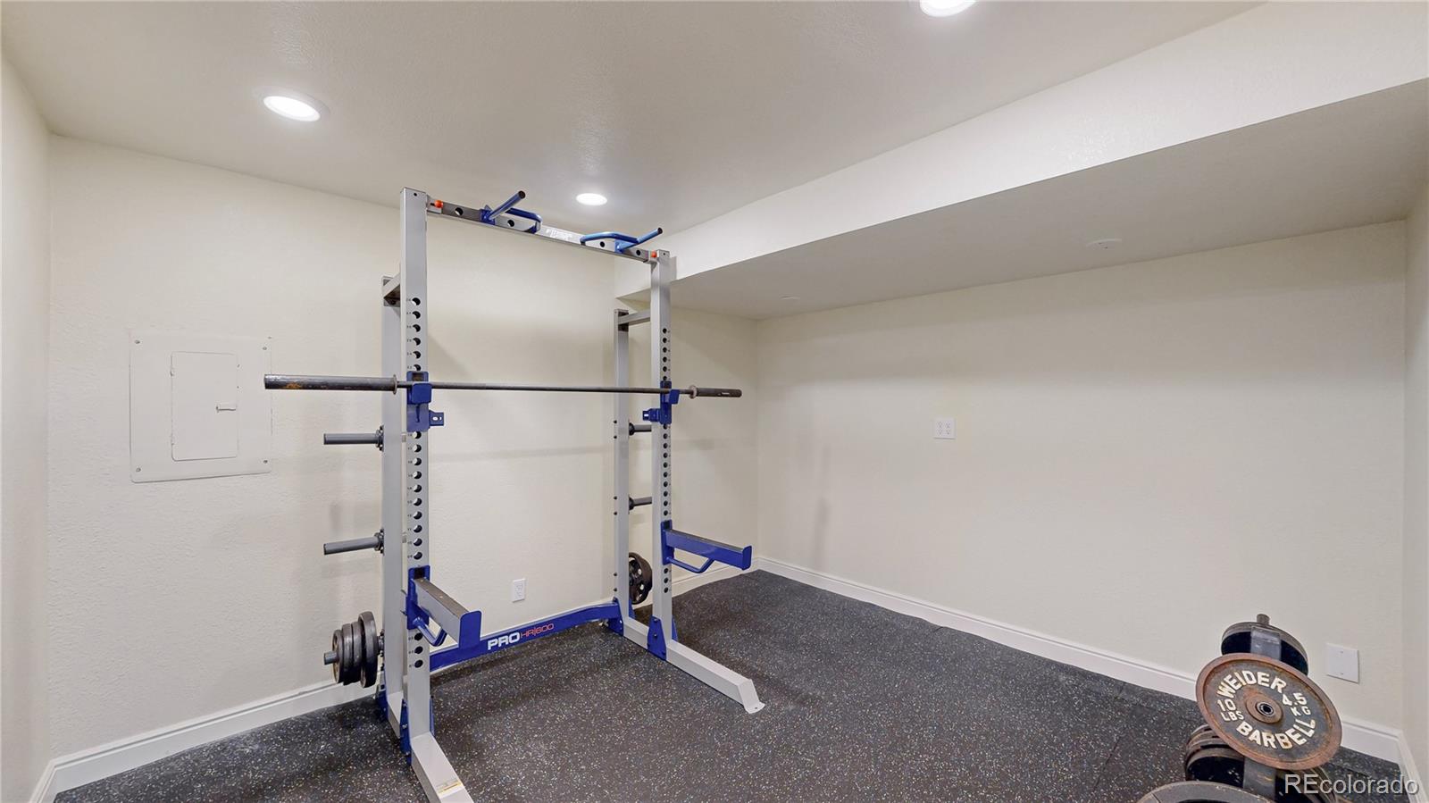 2335 Ranch Drive Westminster, CO 80234 - Photo 31 of 47 a room with gym equipment and windows