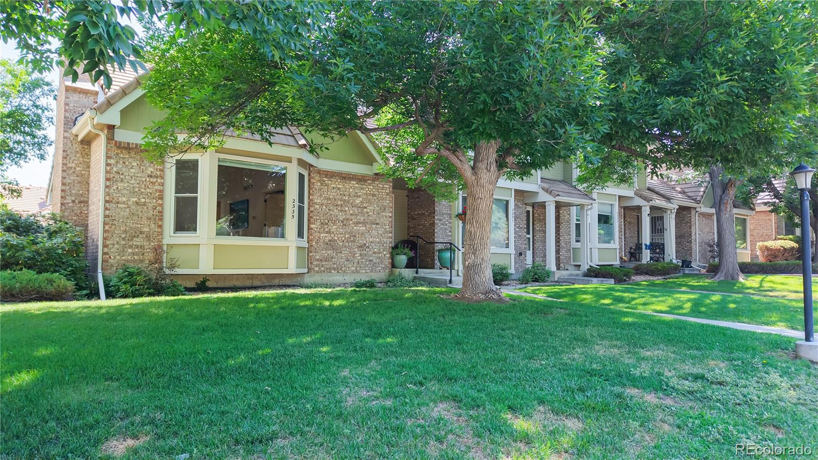 2335 Ranch Drive Westminster, CO 80234 - Photo 35 of 47 a view of a house with a yard and large trees