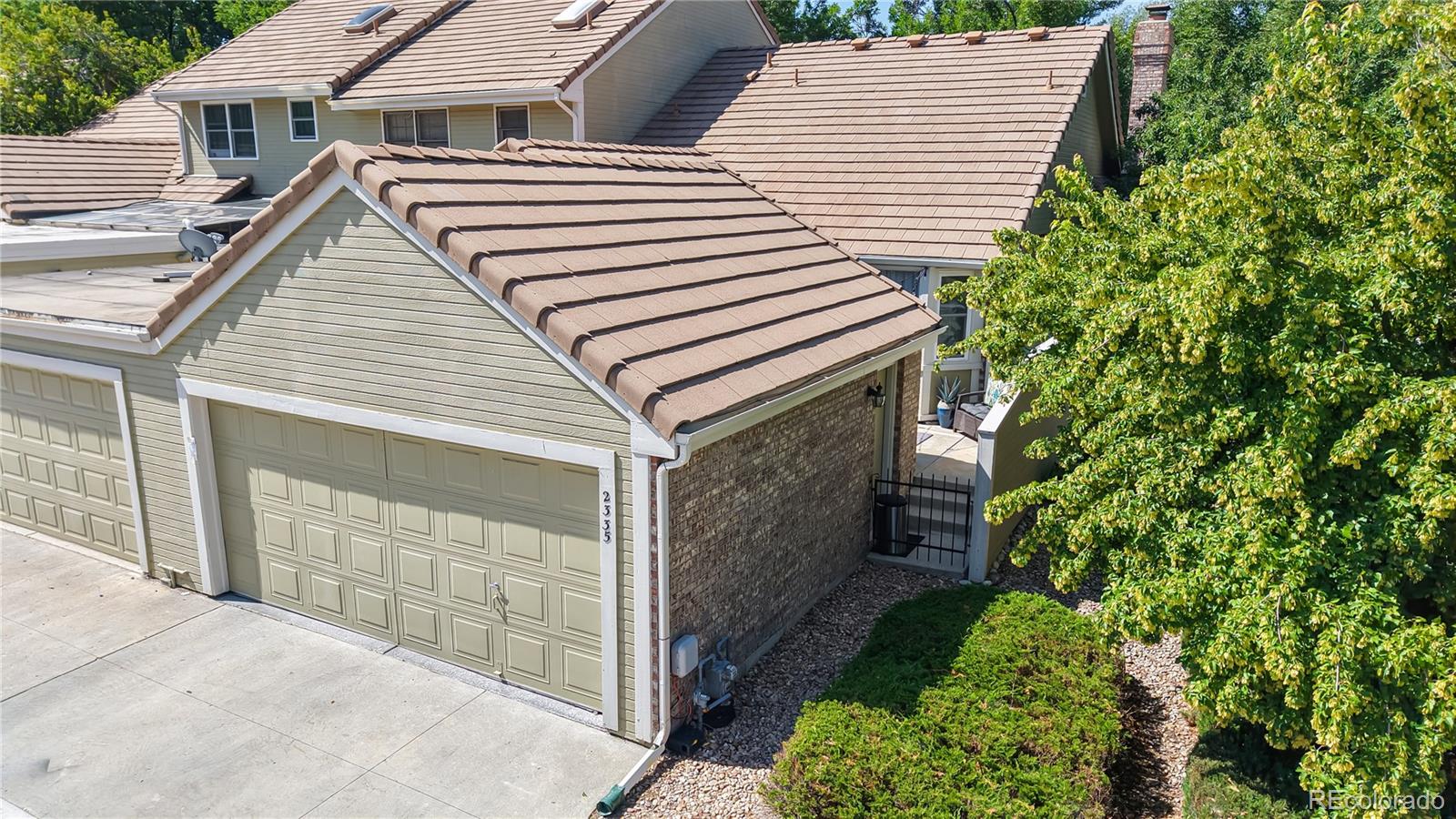 2335 Ranch Drive Westminster, CO 80234 - Photo 38 of 47 a view of a house with a yard and garage