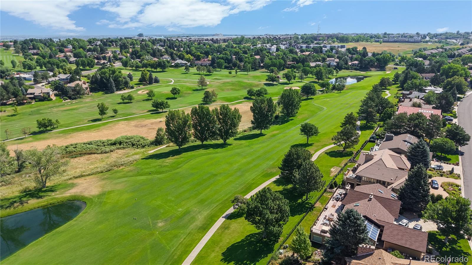 2335 Ranch Drive Westminster, CO 80234 - Photo 44 of 47 an aerial view of a houses with a garden and lake view