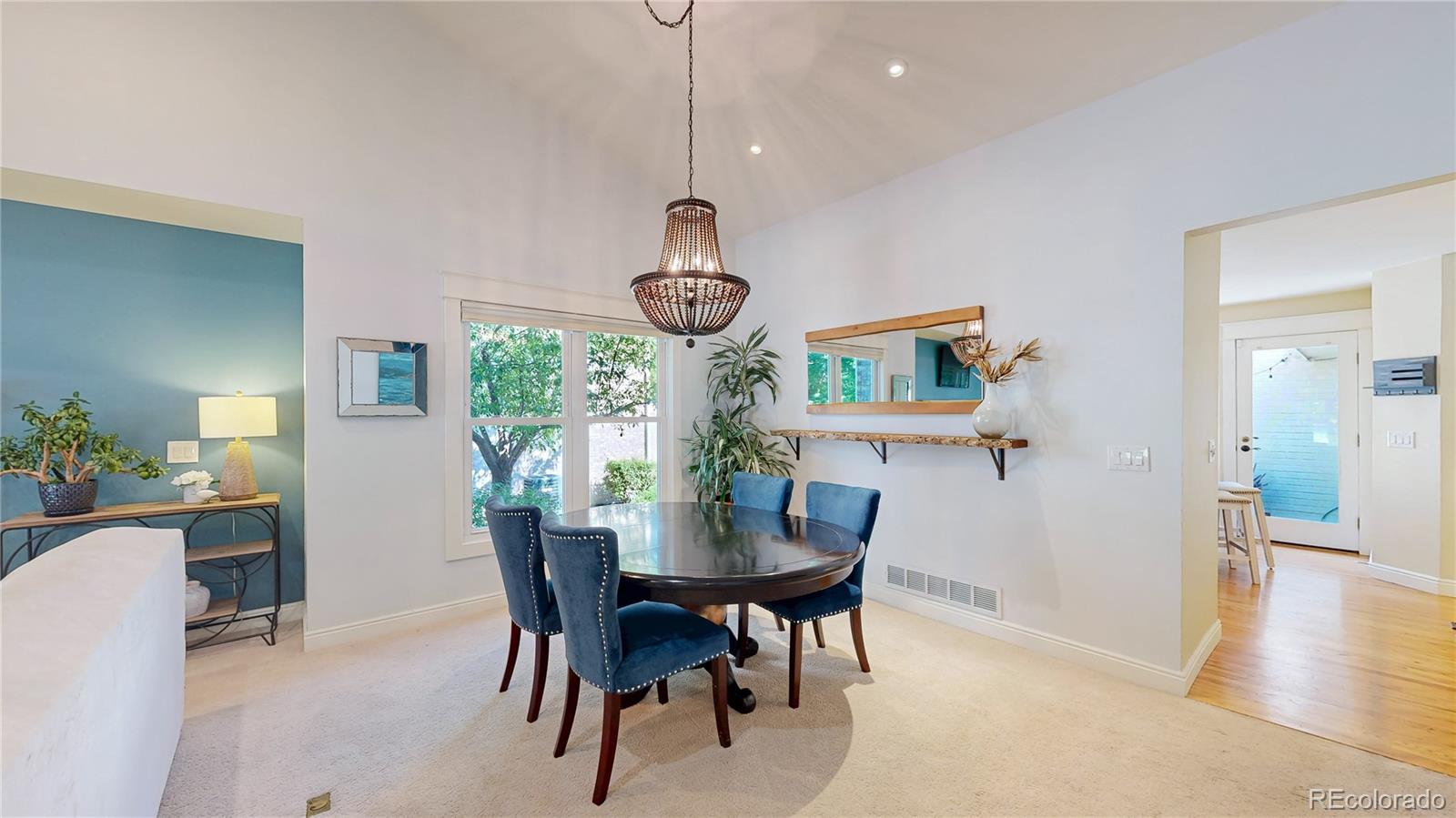 2335 Ranch Drive Westminster, CO 80234 - Photo 9 of 47 a dining room with wooden floor a chandelier a wooden table and chairs
