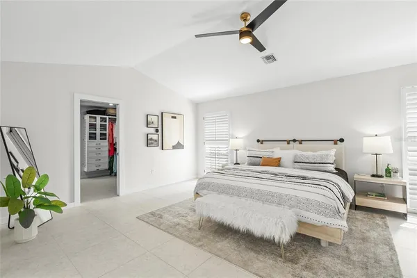 a bedroom with a bed and a potted plant