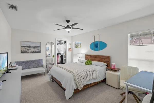 a bedroom with a bed and a chandelier