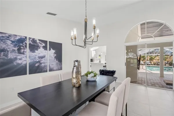 a view of a dining room with furniture and chandelier