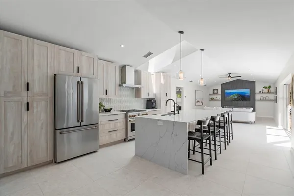 a kitchen with stainless steel appliances a refrigerator sink and cabinets