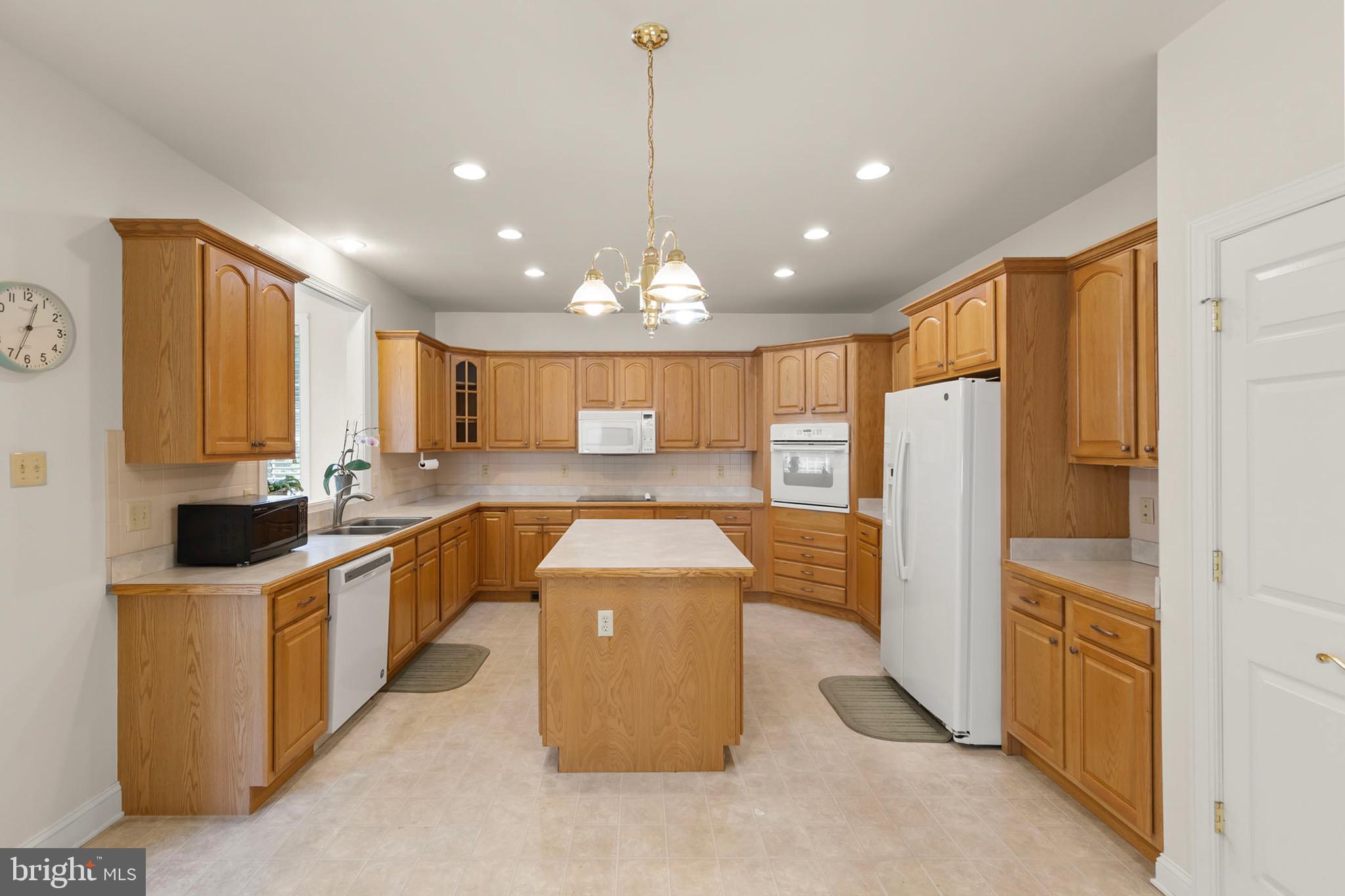152 Harvest Ridge Drive Winchester, VA 22601 - Photo 6 of 43 a kitchen with stainless steel appliances granite countertop a refrigerator a sink dishwasher and a stove with wooden floor