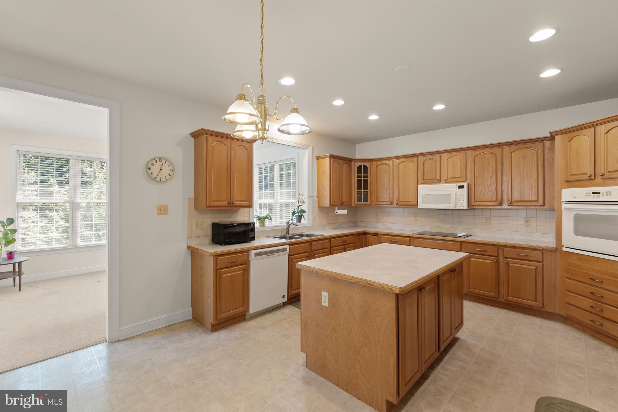 152 Harvest Ridge Drive Winchester, VA 22601 - Photo 7 of 43 a large kitchen with stainless steel appliances granite countertop a stove a sink a refrigerator and a granite counter tops