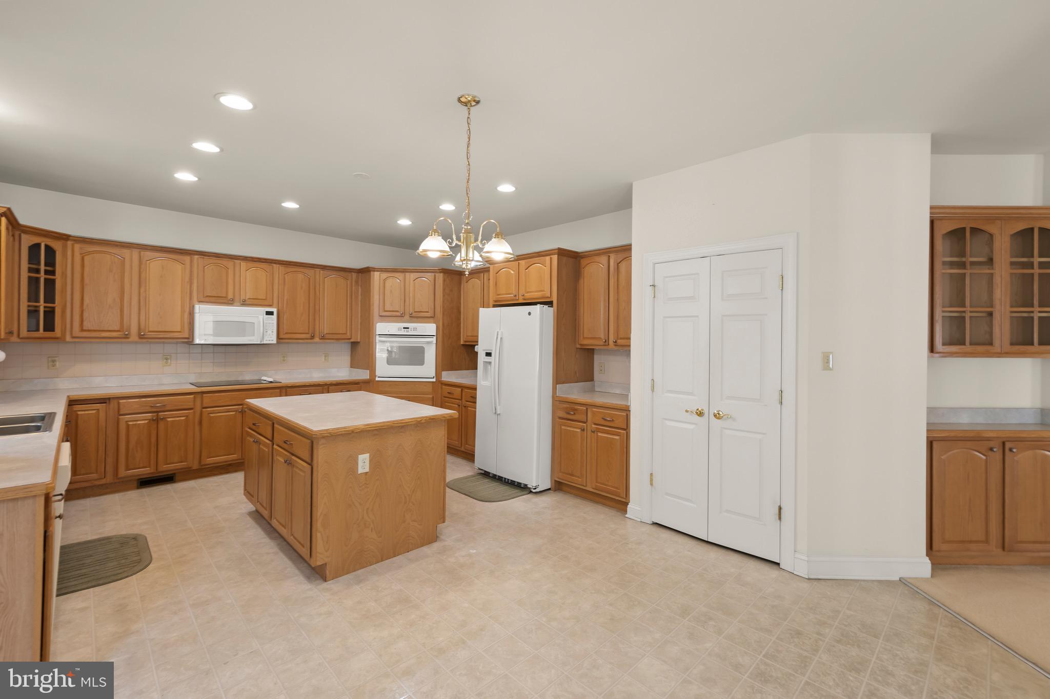 152 Harvest Ridge Drive Winchester, VA 22601 - Photo 10 of 43 a kitchen with stainless steel appliances granite countertop a refrigerator a sink and a stove