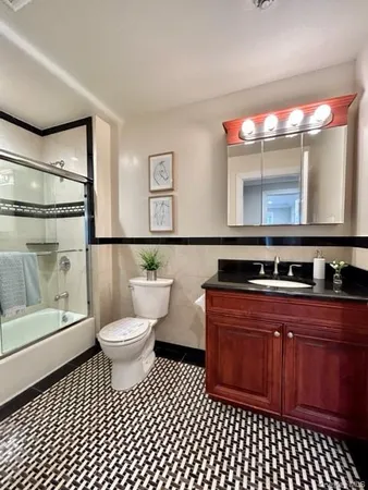 a bathroom with a sink a toilet and mirror