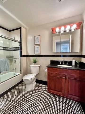 a bathroom with a sink a toilet and mirror