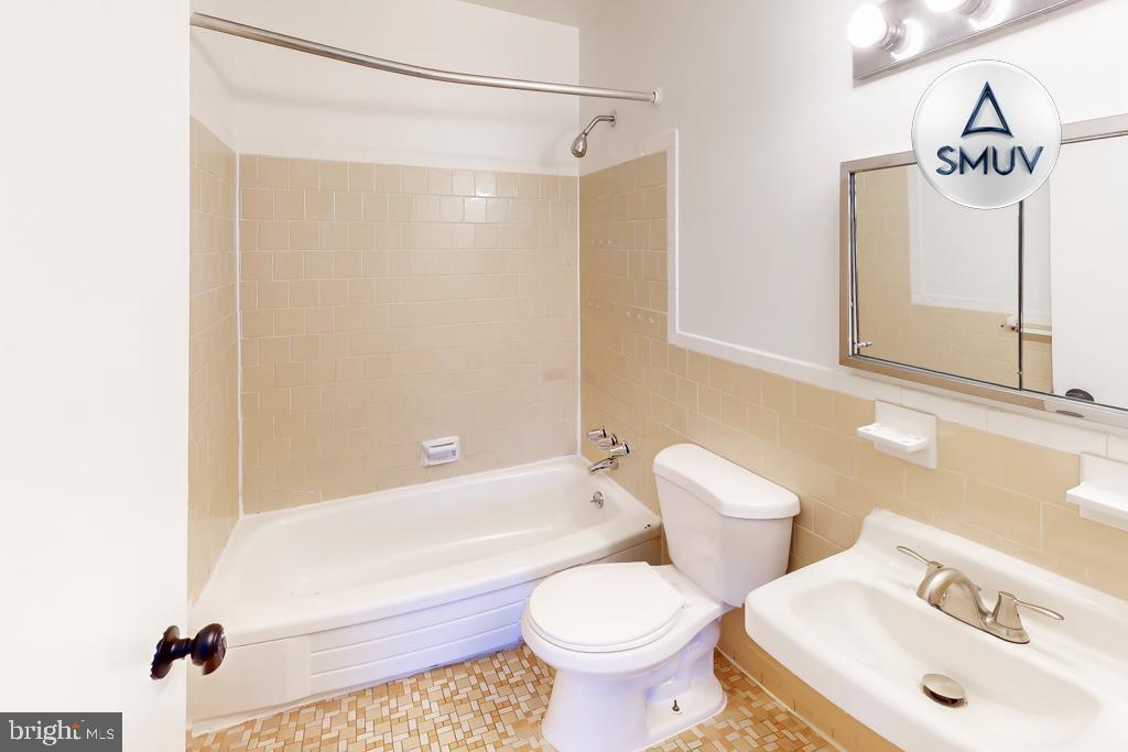 1504 Upshire Road, Unit F2 Baltimore, MD 21218 - Photo 14 of 22 a bathroom with a sink toilet and shower