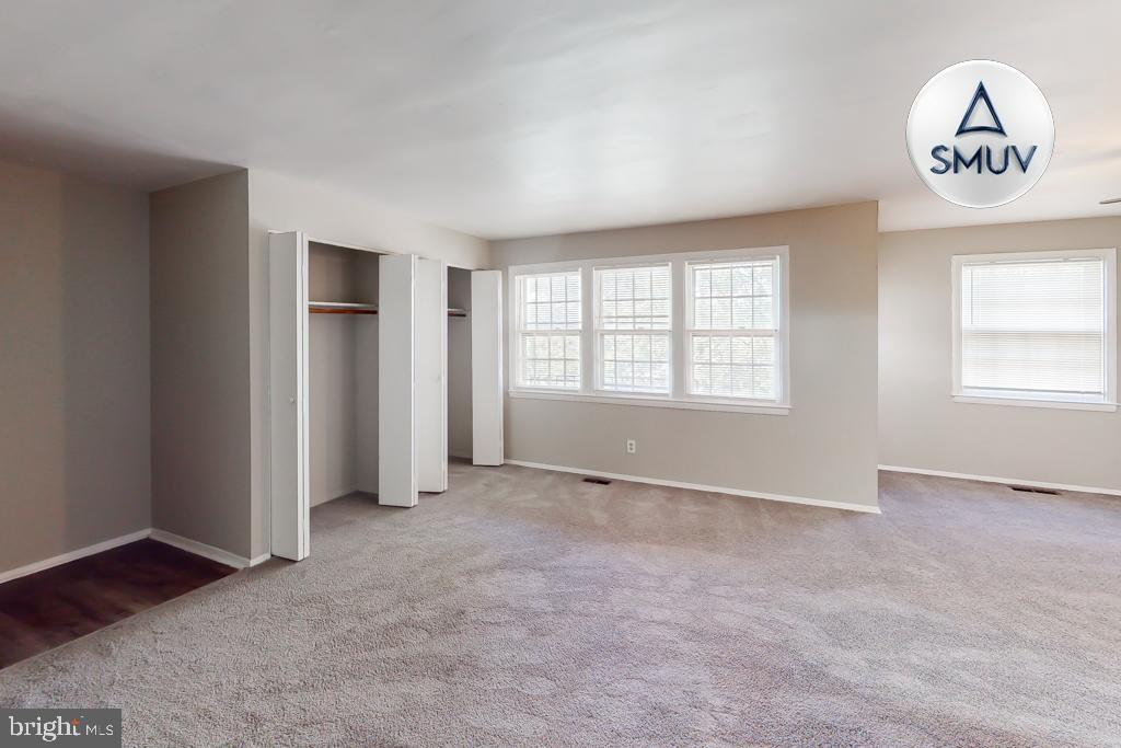 1504 Upshire Road, Unit F2 Baltimore, MD 21218 - Photo 16 of 22 an empty room with a window and a kitchen