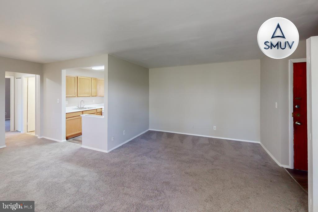 1504 Upshire Road, Unit F2 Baltimore, MD 21218 - Photo 19 of 22 a view of a kitchen with fridge and wooden floor