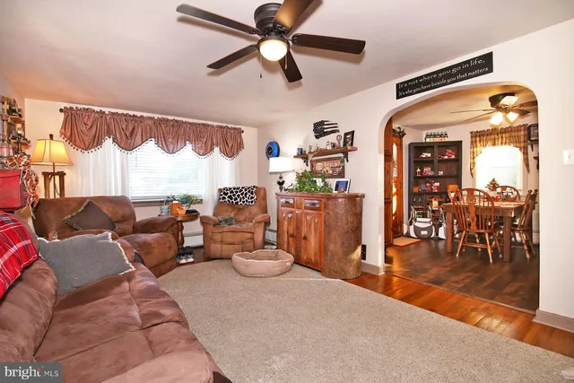 a living room with furniture a rug and a fireplace