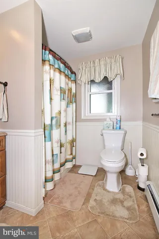 a bathroom with a toilet sink and shower