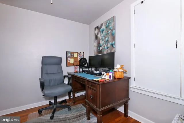 a view of a workspace with furniture and a window
