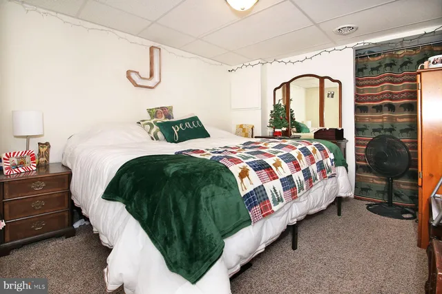 a bedroom with bed and a chandelier