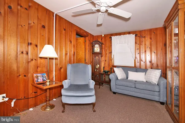 a bedroom with furniture and a large window