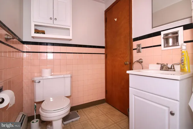 a view of a house with a small yard and wooden fence