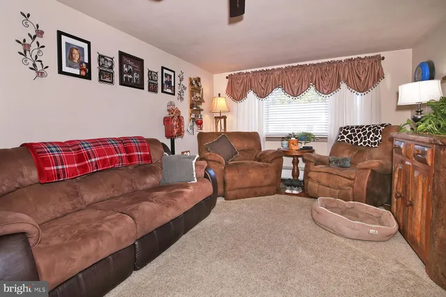 a living room with furniture and a lamp