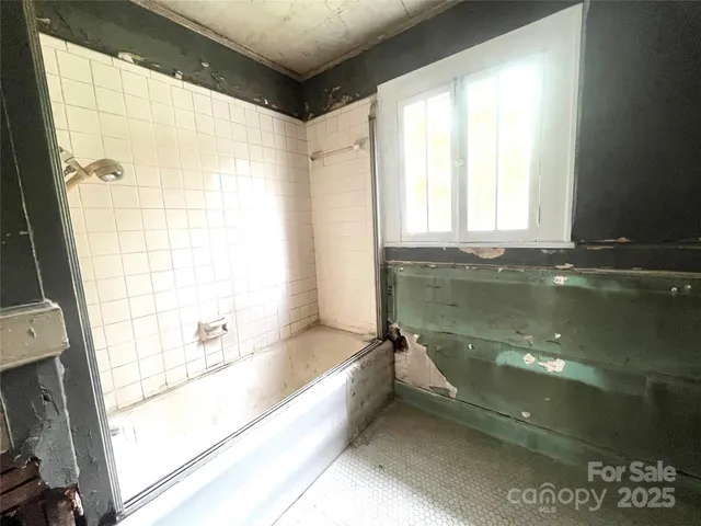 a view of a room with gym equipment and a window