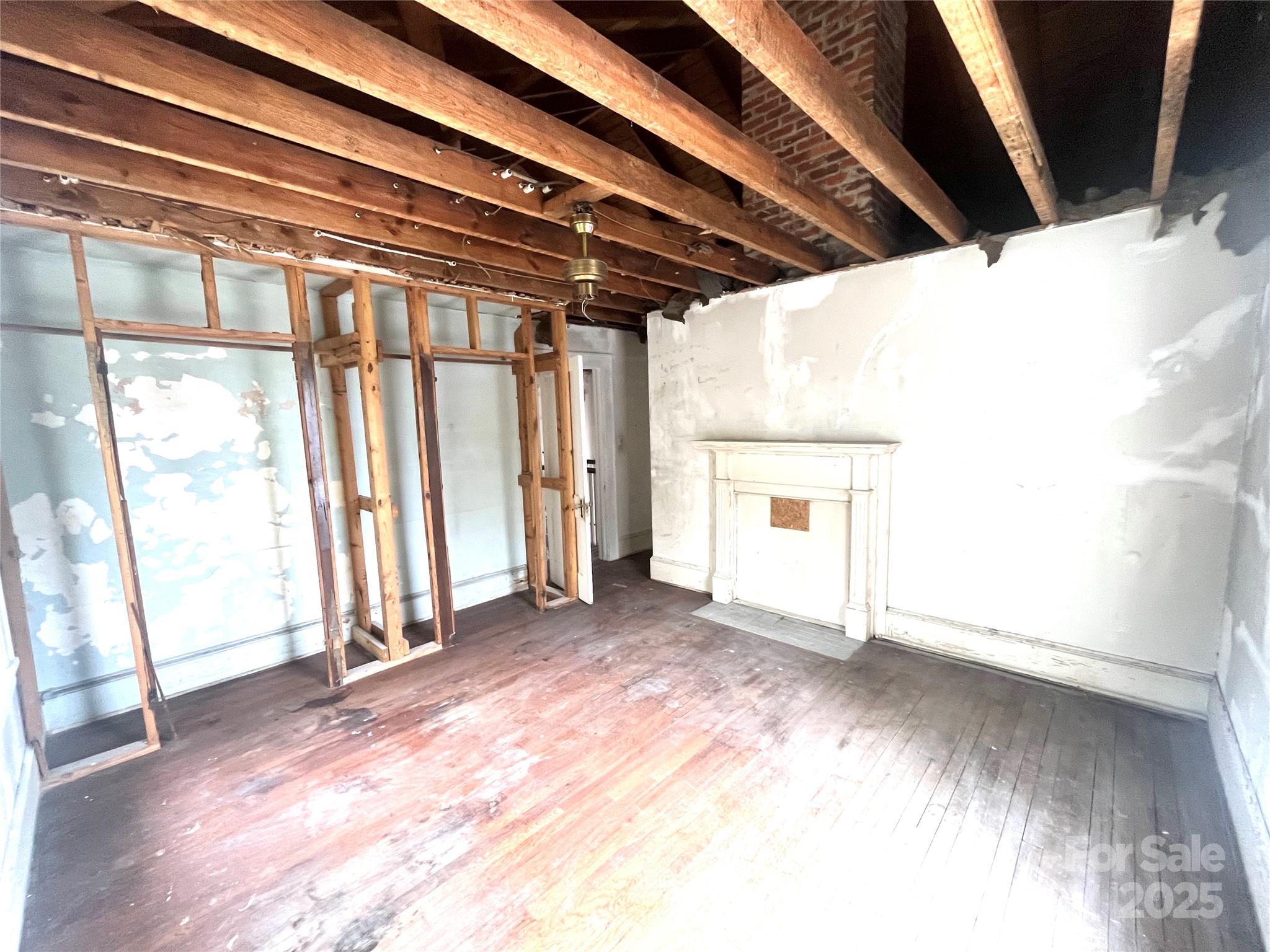 308 Elm Street Lancaster, SC 29720 - Photo 17 of 33 a view of empty room with wooden floor and fan