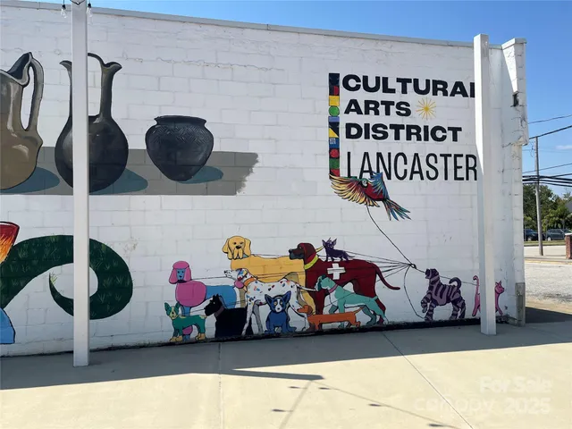 a tall brick building with a yard in front of it