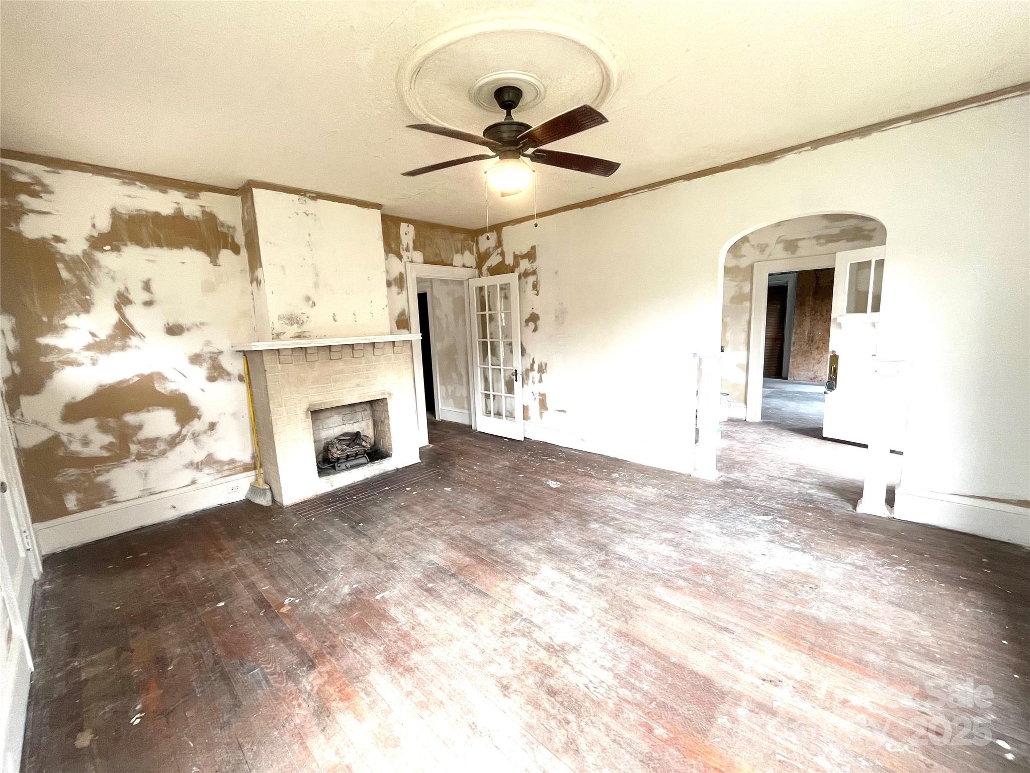 308 Elm Street Lancaster, SC 29720 - Photo 3 of 33 a view of empty room with a fireplace and fan