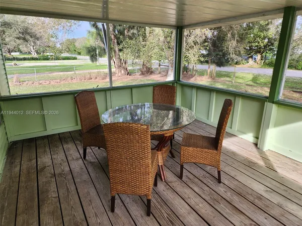 a view of a chairs and table in balcony