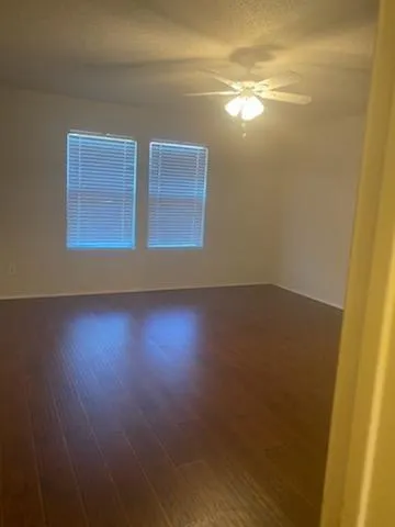 en empty room with wooden floor and window