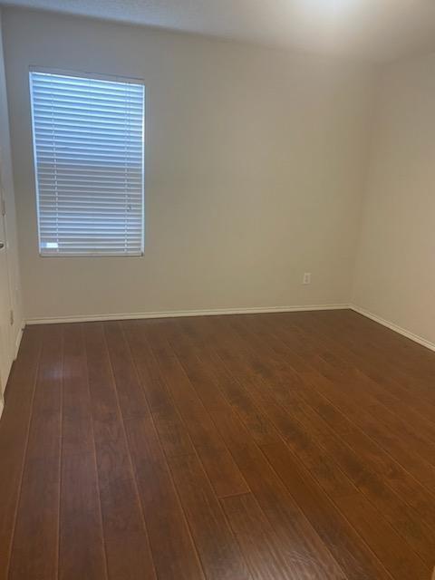 2217 Teddy Roosevelt Drive McKinney, TX 75072 - Photo 8 of 10 an empty room with wooden floor and windows