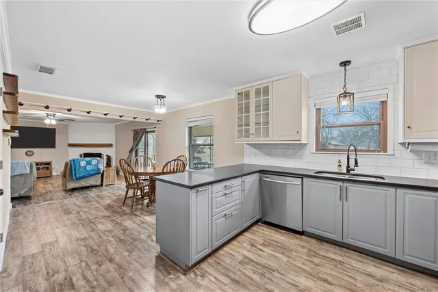 a kitchen with sink cabinets and stove top oven
