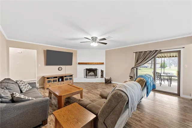 a living room with furniture a flat screen tv and a fireplace