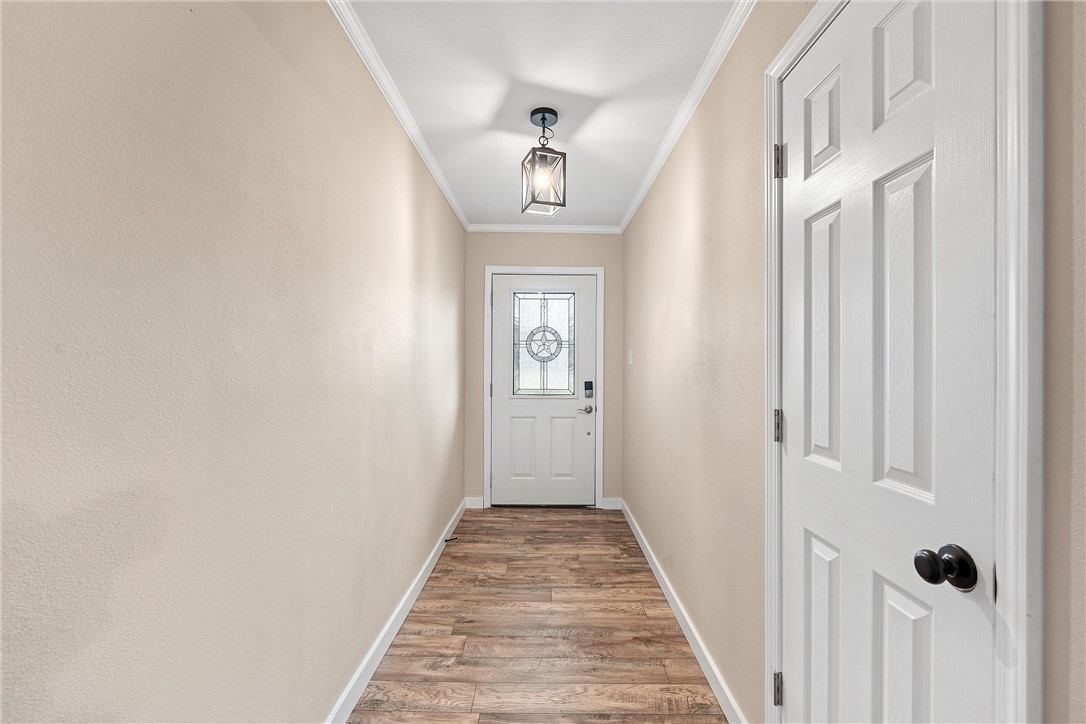 220 Ivy Lane Hewitt, TX 76643 - Photo 6 of 29 a view of a hallway with wooden floor and entryway