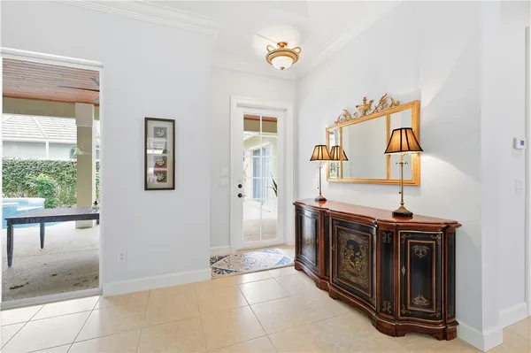 a view of a hallway that has a table and chairs