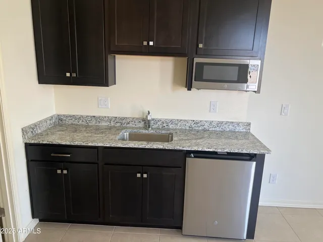 a kitchen with granite countertop a cabinets and steel appliances